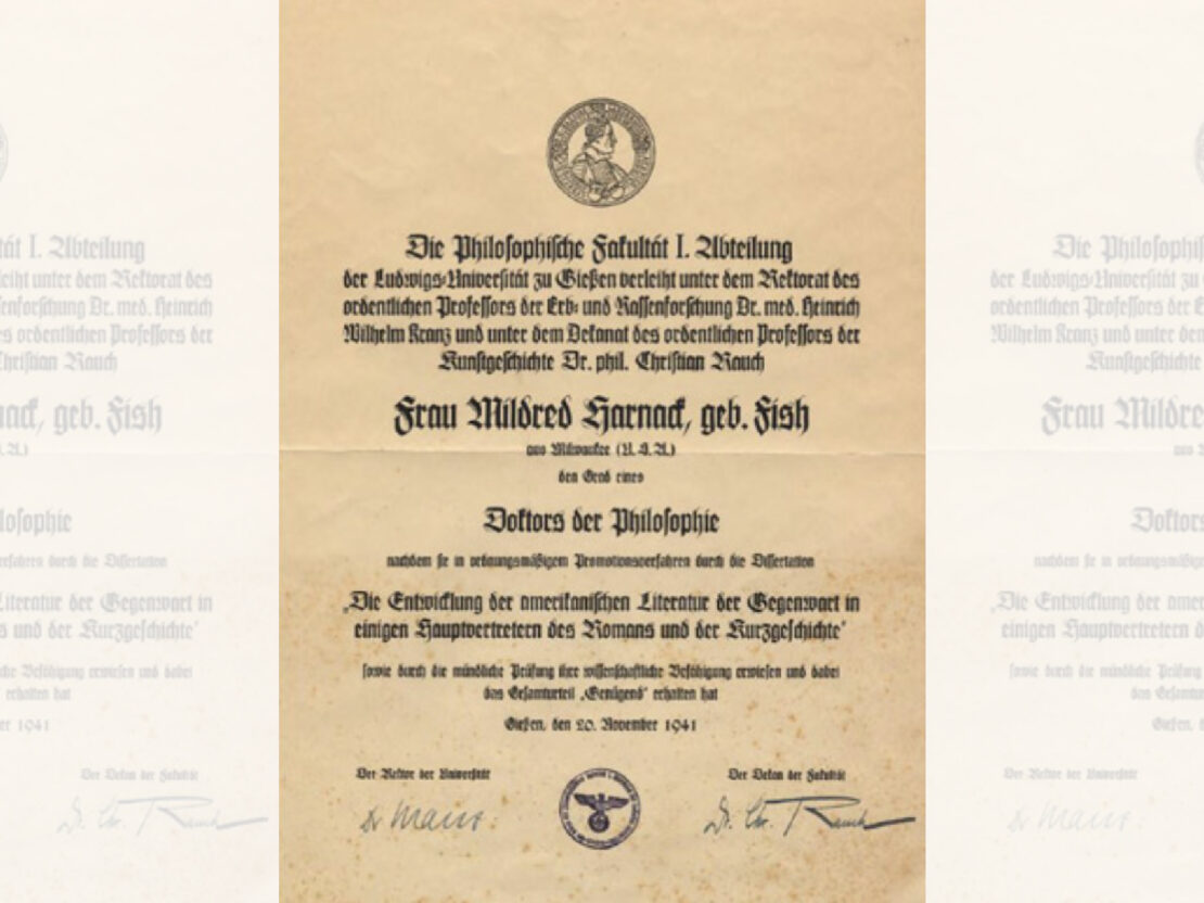 A yellow tinted image showing a paper with formal script on it in German recognizing her Doctorate degree.