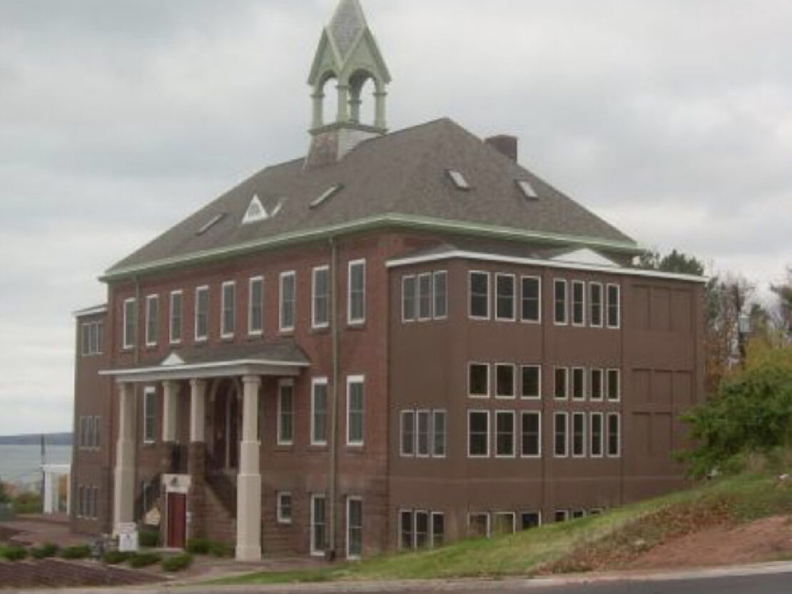 A color photograph of a red brick building.
